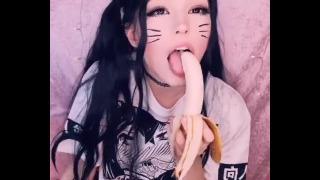 Kitty girl sucking a banana